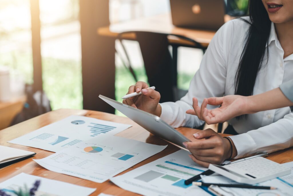 Close-up of a group of businesswoman a meeting evaluate analytical using a chart calculator tablet c